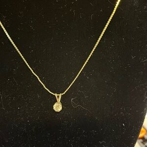 Crystal stone with gold tone necklace.